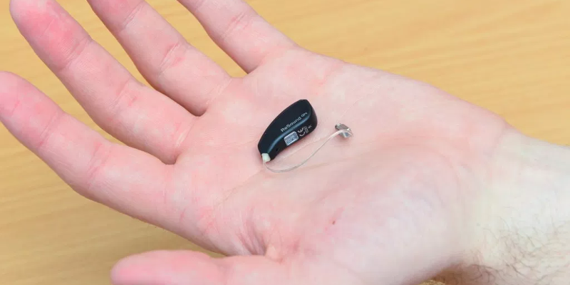 hearing aid in a man's open palm