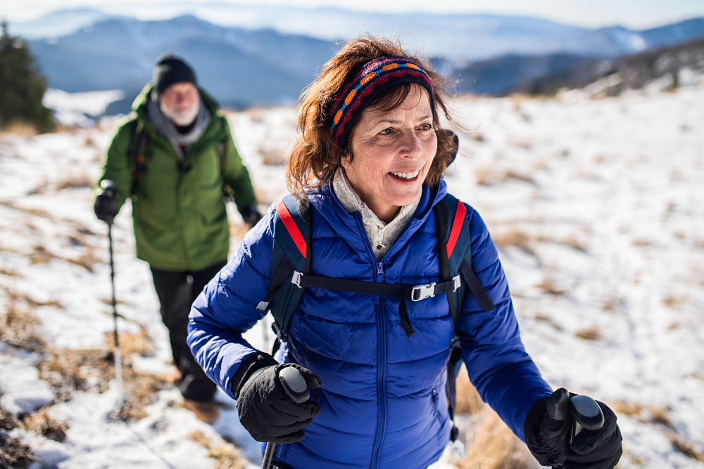senior couple walking in the snow
